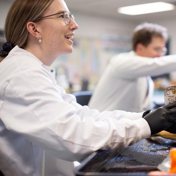 VIU student holding a fish in the fish biology lab