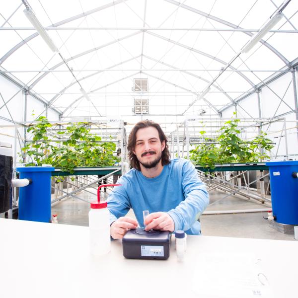 VIU student in the aquaponics greenhouse