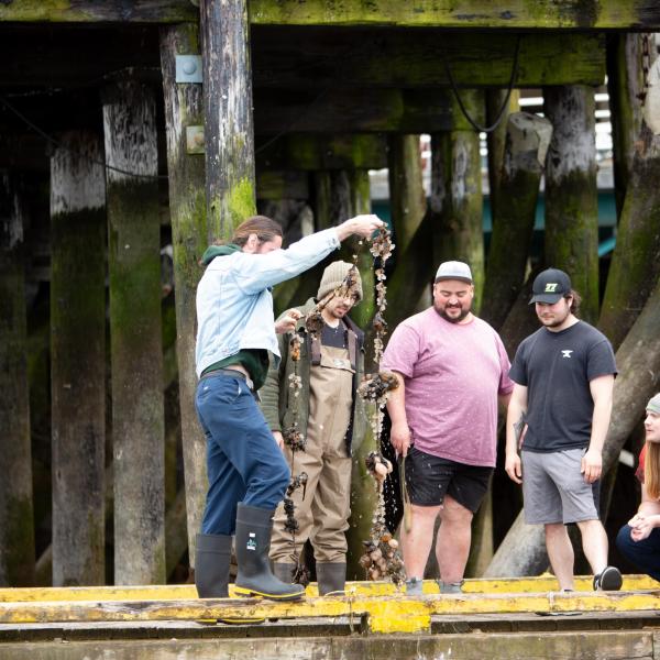 Fish & Aqua students standing at the dock and pilings