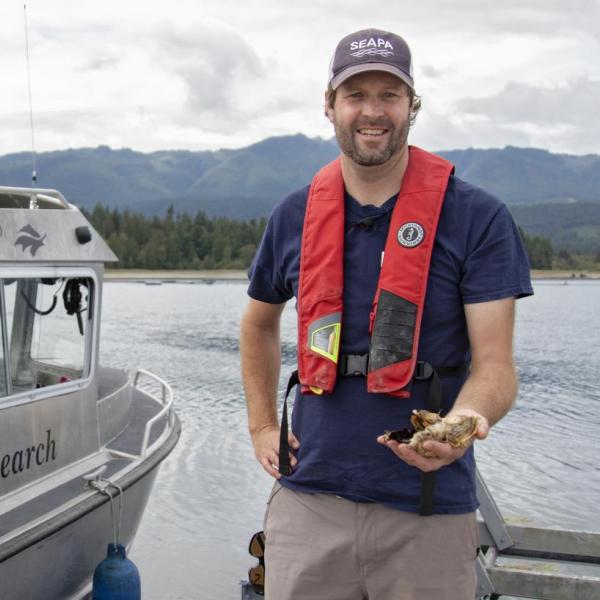 Dr, Tim Green holding an oyster