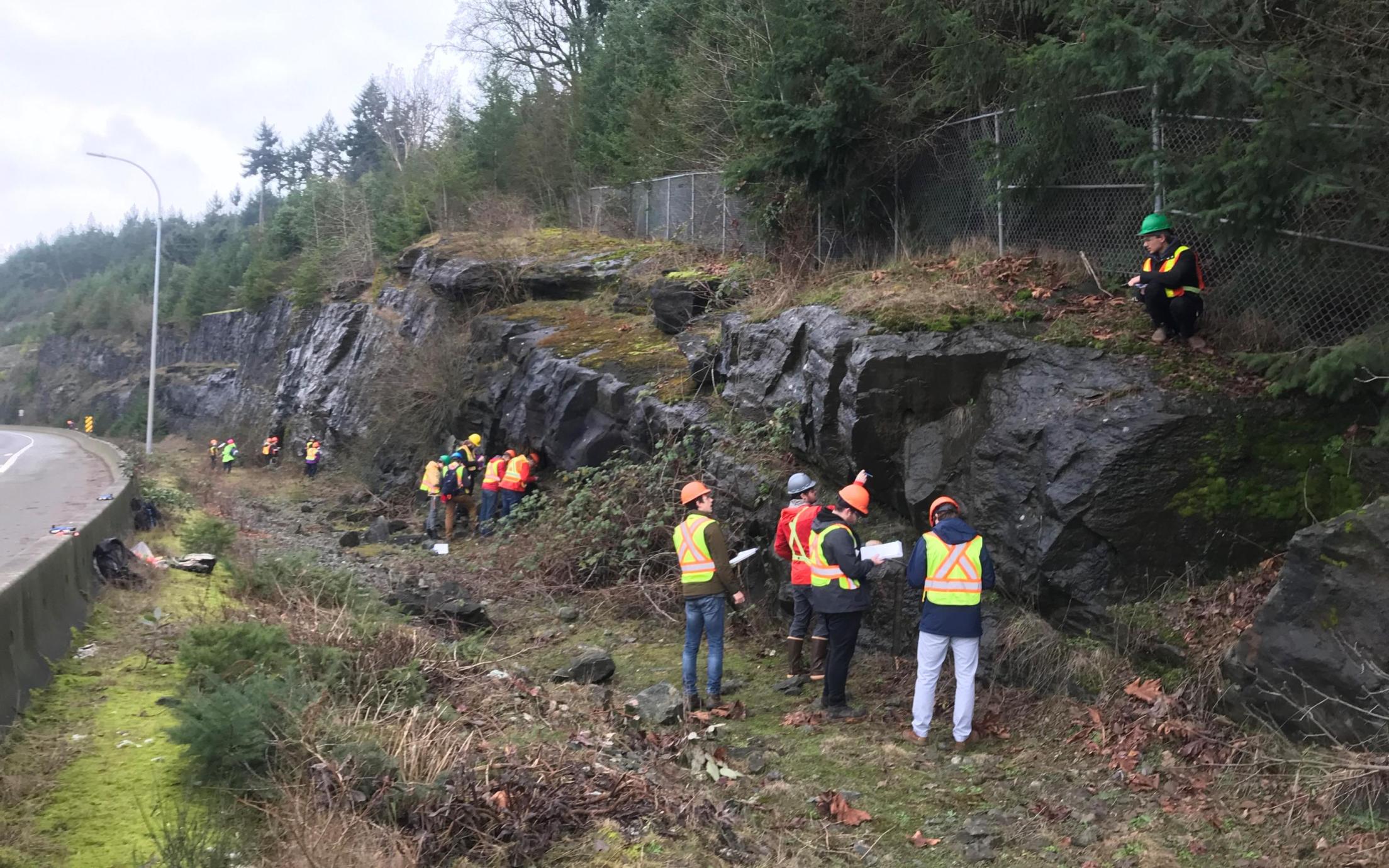 Students learning to take structural measurements and make geological observations at Malaspina Cut
