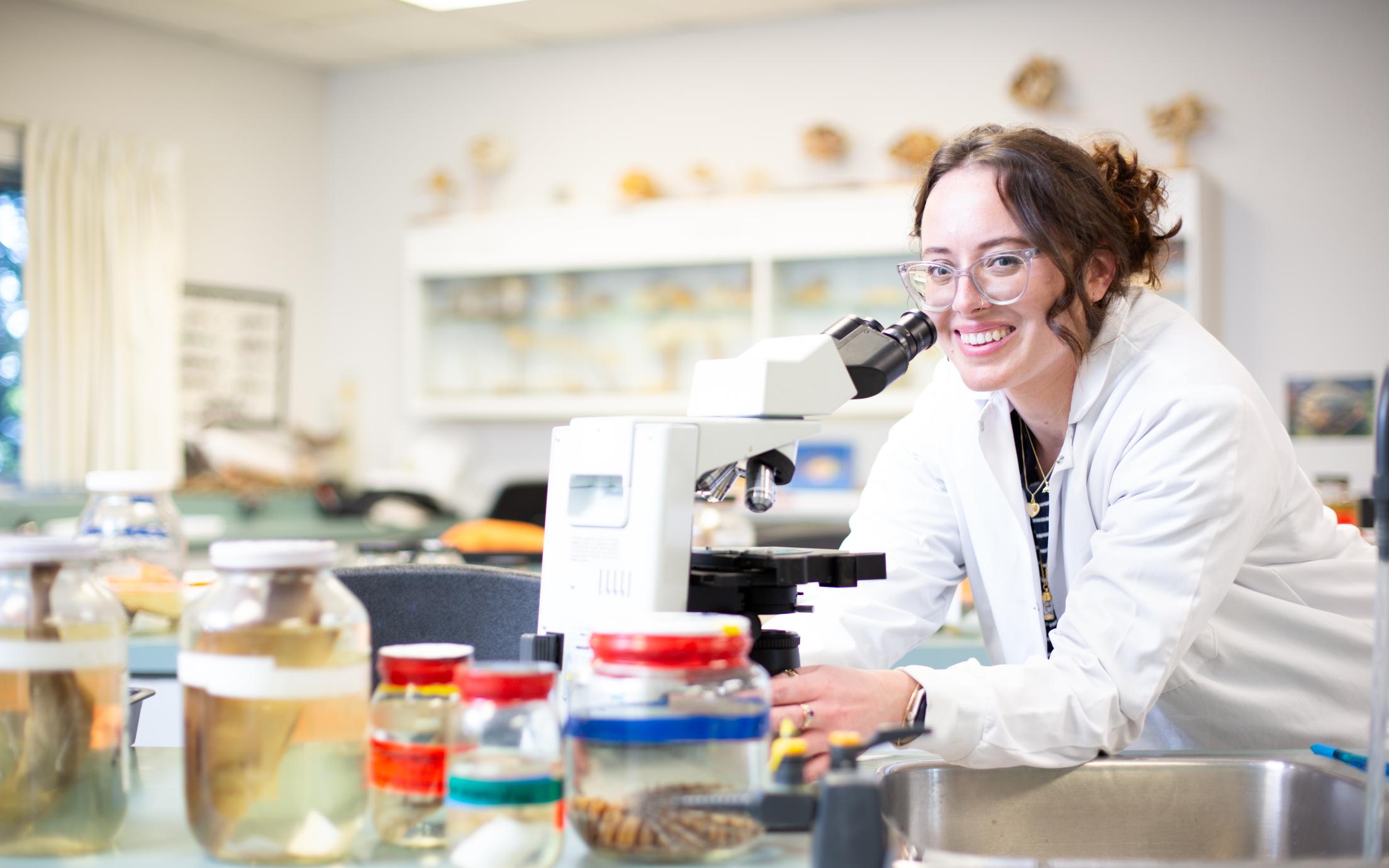 VIU student smiling at the microscrope