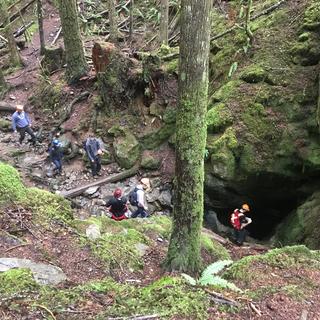 Students exploring the cave system at Horne Lake during a GEOL401 field trip
