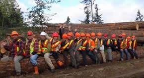 RMOT students all sitting on a fallen tree