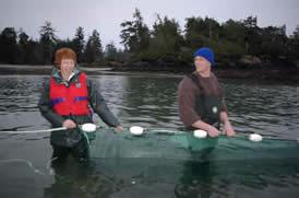 Two RMOT students holding a fish net up in a river