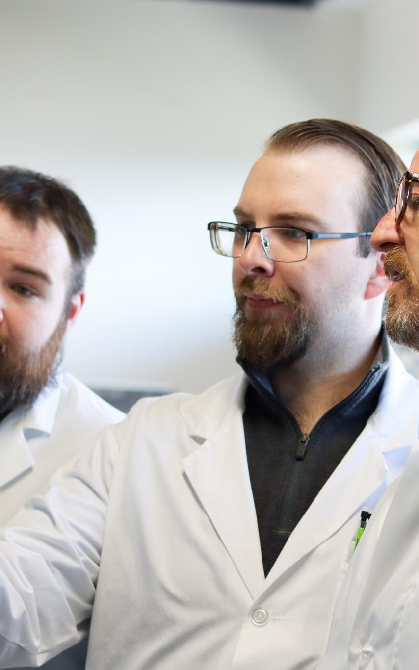 VIU students and professor looking at a microbiology sample